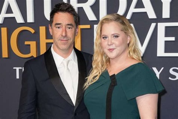 
Amy Schumer Pokes Fun at Husband Chris Fischer on ‘SNL’ : ‘We Play the Game — Autism or Just a Man?’ 