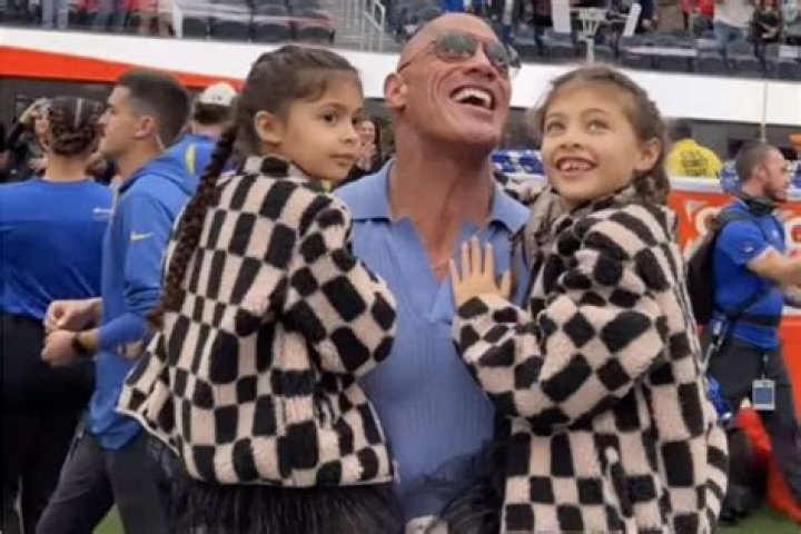 Dwayne Johnson Holds Daughters in His Arms While Watching Wife Lauren Hashian Sing the National Anthem